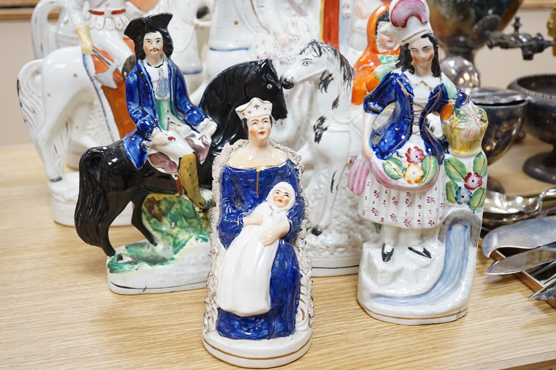 Two pairs of Staffordshire flat backs of figures on horseback, two others, a mother and child and flower seller